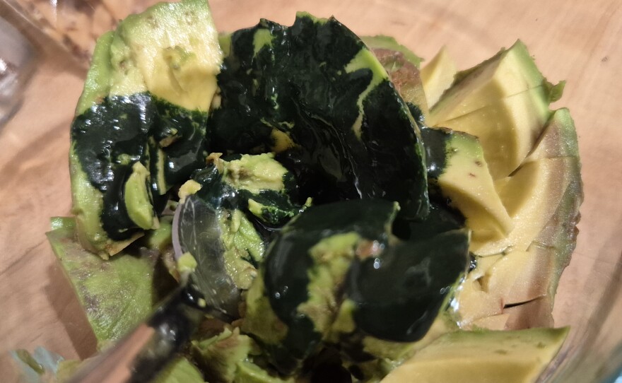 Making guacamole with spirulina added