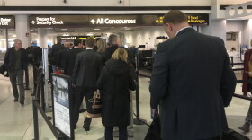 Passengers wait in line at a T.S.A. Security Checkpoint at Charlotte Douglas International Airport a week before holiday travel season begins.