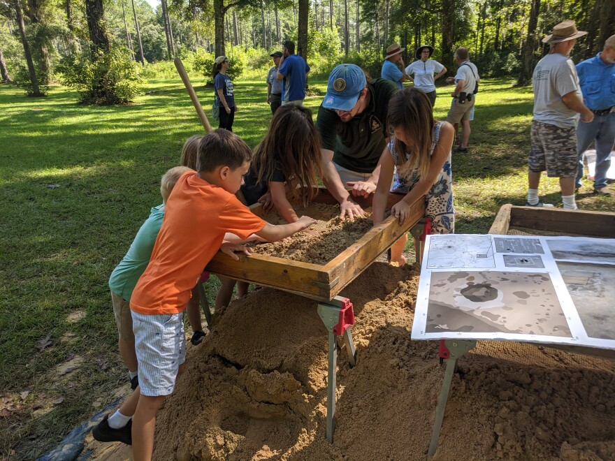 Curious young "researchers" carefully sift through soil excavated from near the park's burial mounds in hopes of finding ancient artifacts.