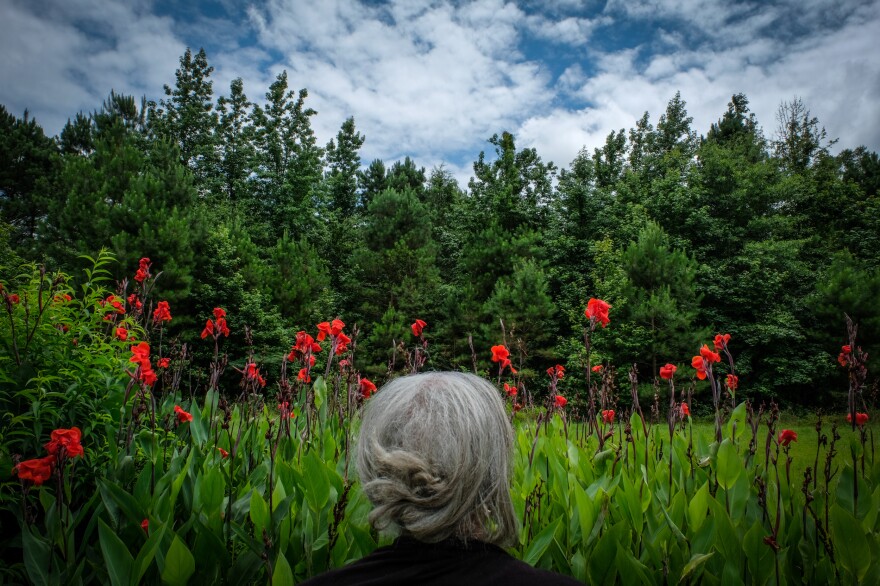 The photographer's aunt Jean stands in front canna lilies in Dalark, Arkansas.