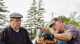 Designated safe-crackers peer into the metal box they found inside the century-old safe in Harrisville, Michigan on Sept. 20, 2026.