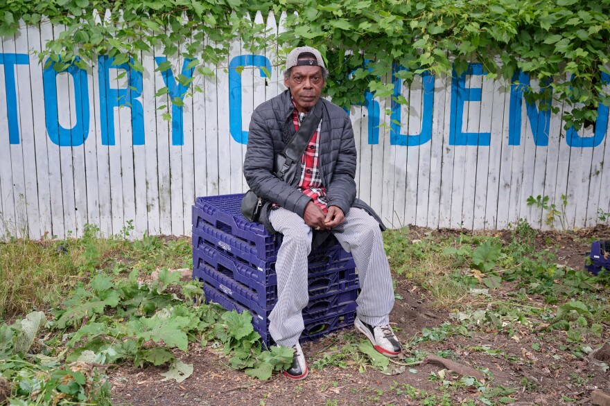 Mitch on a plot of land that has a community garden and the product pick-up initiative. Mitch is connecting newly arrived migrants with community outreach and job opportunities.