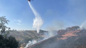 A helicopter makes a water drop on the September 6 Caballo Fire in the Santa Ynez Valley. Homes were threatened, but the fire was stopped before it could reach them.