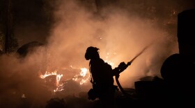 Firefighters protect homes in Christmas Valley from the Caldor Fire Monday, Aug. 30, 2021.