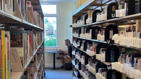 FILE: Blare Stew uses the Belmont Library in Multnomah County last summer. Libraries in some Oregon cities and counties are facing financial cuts that could result in increased stress for librarians.