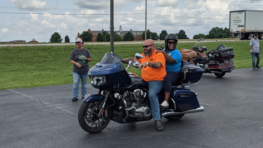 Daniel Conner takes Candra Barnett for a ride on his motorcycle.