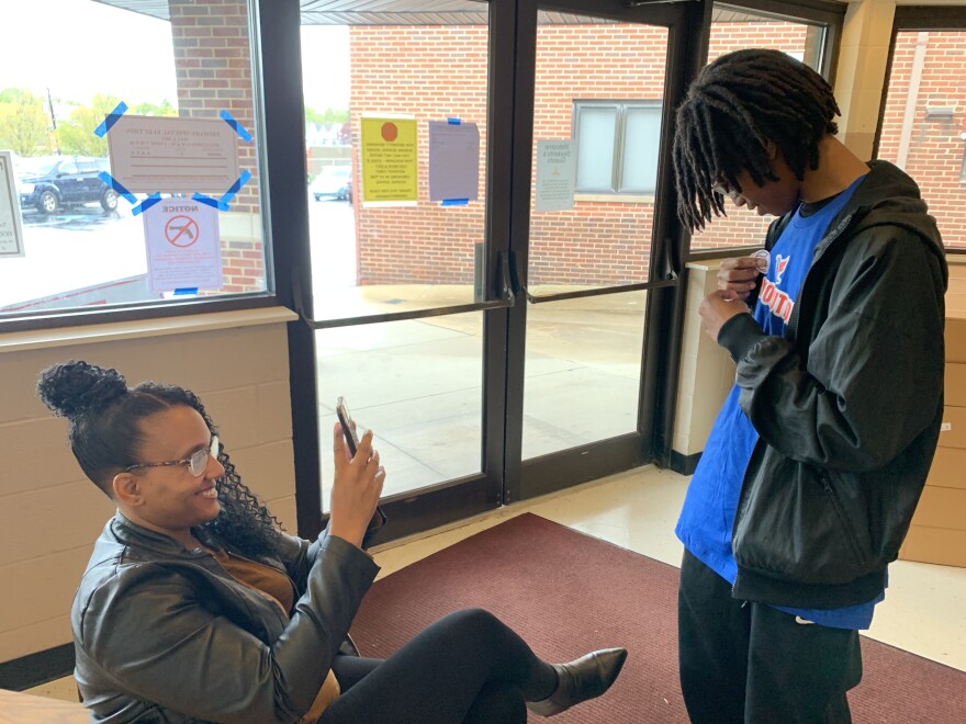 19-year-old Omari Amos' mother takes his picture after he voted for the first time.