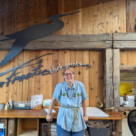 Sandra Grahl stands in the Benzie County studio of the late artist Gwen Frostic. (Photo: Natalie Reitz / Transom Story Workshop)