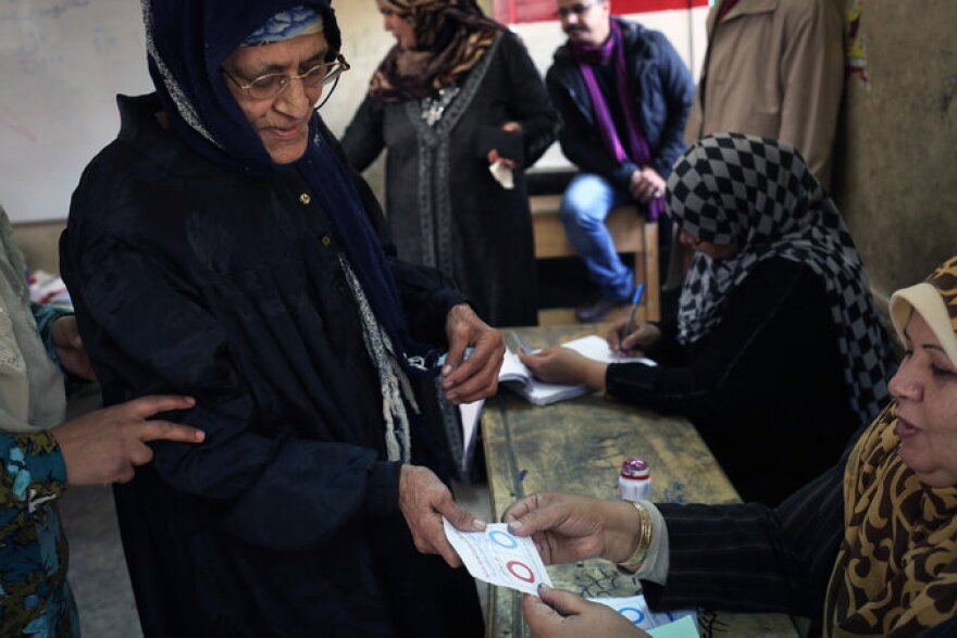 An Egyptian woman a ballot for the constitutional referendum at a polling station in Cairo.