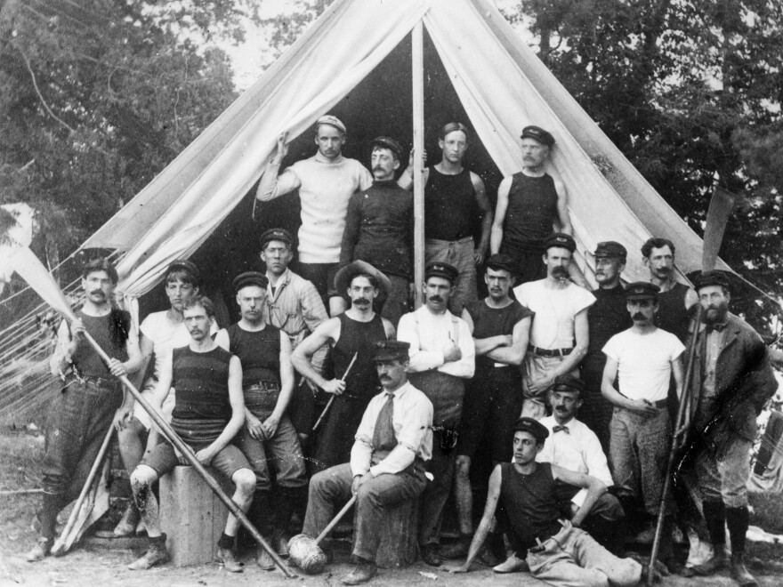 YMCA camp leaders at Camp Dudley in New York. Sumner Dudley, founder of the camp, sits in the center with a mallet.