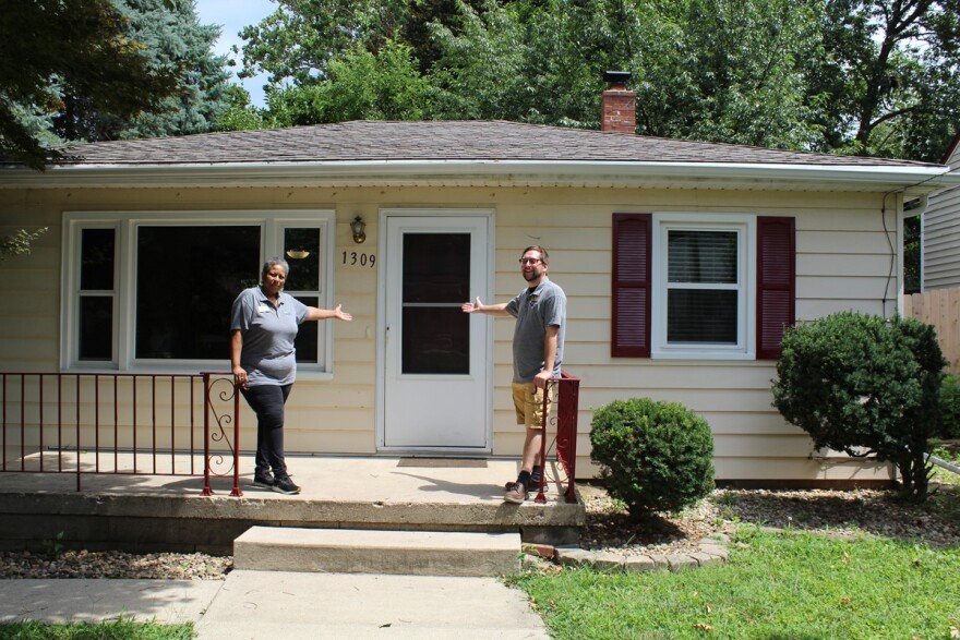 Two homeowners celebrate their newly purchased home. 