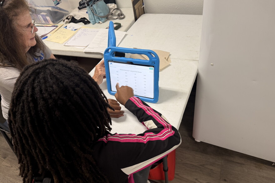 PEAK Literacy tutor Mary Ellen Delaplaine works with Kristina Keith on a reading activity at Sweetwater Square in Gainesville, Fla., on Sept. 16, 2026. Students use tablets and other learning materials during tutoring sessions.
