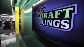 Large DraftKings logo is displayed on a wall