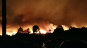 A wildfire rages in Ventura County, Calif., on Tuesday in this still image taken from social media video.