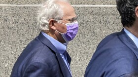 Former U.S. Rep. Stephen Buyer, left, trails his lawyer as he leaves Manhattan federal court after pleading not guilty to charges that he participated in an insider trading scheme while working as a consultant, July 27, 2022, in New York. Buyer went on trial Wednesday, March 1, 2023, on insider trading charges, accused of illegally garnering stock windfalls by exploiting his consulting clients' corporate secrets years after he left Congress.