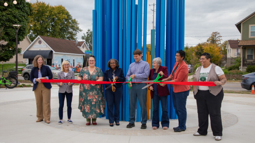 Eleanor Moreno (far right) helps cut the ribbon for Unity Park with other Grand Rapids officials. The organ pipes behind them are from St. Joseph the Worker Church and were repurposed as a water sculpture.