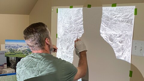 Artist Rad Smith works on the Deer valley map in his Bozeman, Montana, home studio. It took him 70 hours to paint the new map for Deer Valley’s vast expansion. That’s after he skied existing runs and talked to ski patrollers and others who know the mountain. He also pored over the master plan, photos and drone footage before taking brush in hand.
