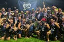 Members of St. Louis Australian Rules Football team pose with their USAFL championship trophy during a victory photoshoot after the team beat Denver 52-20 on October 19, 2025. 