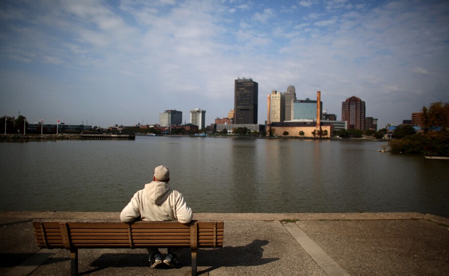 A man sits on a park bench near downtown Toldeo, which is home so far to eight Syrian refugee families.