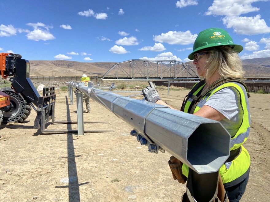 Paige Den-dekker works on tightening brackets to support structures used on large-scale solar farms during training at the Northern Nevada Laborers Training Center in Storey County, Nev., on June 23, 2023.