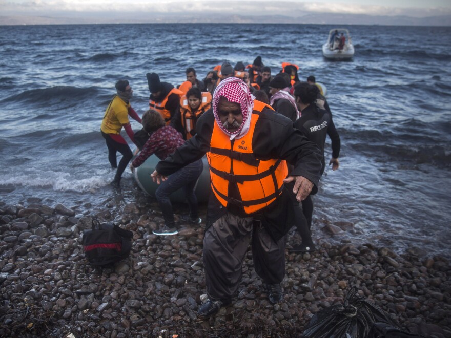 An Iraqi man disembarks from a dinghy on a beach after his trip with other refugees and migrants from the Turkish coast to the northeastern Greek island of Lesbos on Friday.