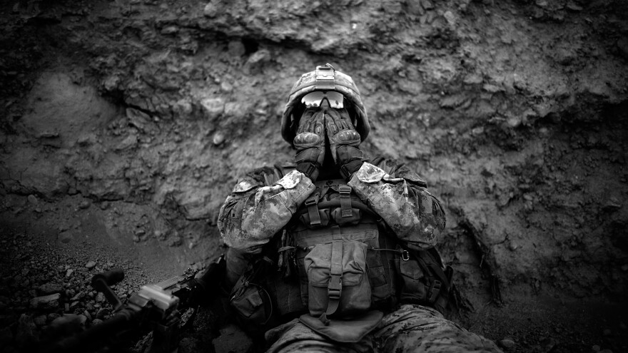 Marine Lance Cpl. Anthony Espinoza wipes the sweat out of his eyes at the end of a daylong patrol out of the Sangin District in southern Afghanistan in May 2011.