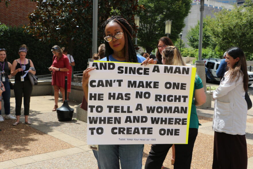 A protester holds a sign after Tennessee’s full abortion ban — called the Human Life Protection Act — took effect in 2022.