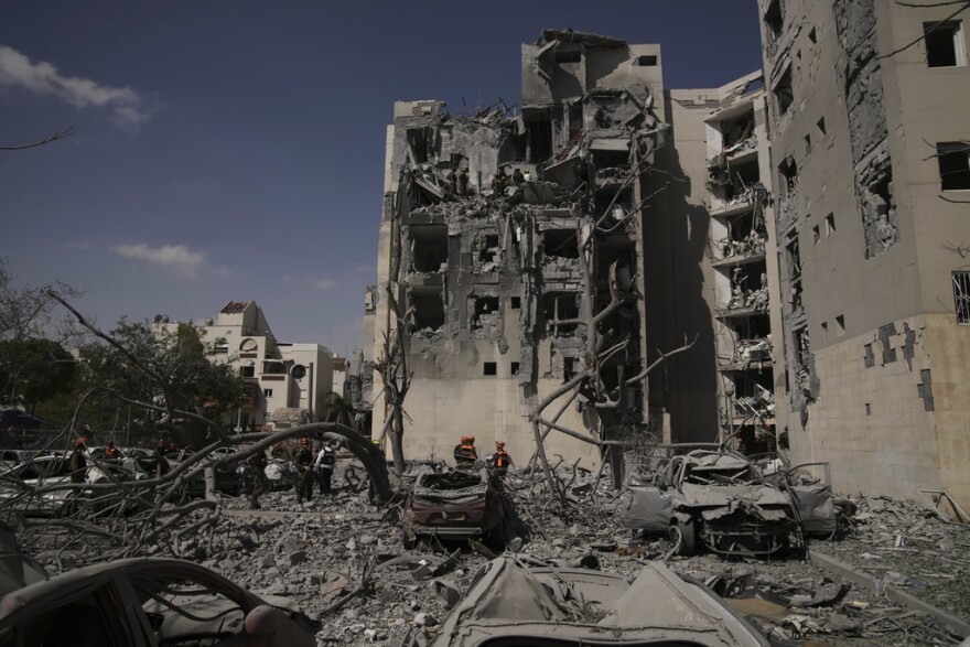 Israeli security forces inspect the site struck by an Iranian missile strike that killed several people, in Beersheba, Israel, on Tuesday, June 24, 2025. (AP Photo/Leo Correa)
