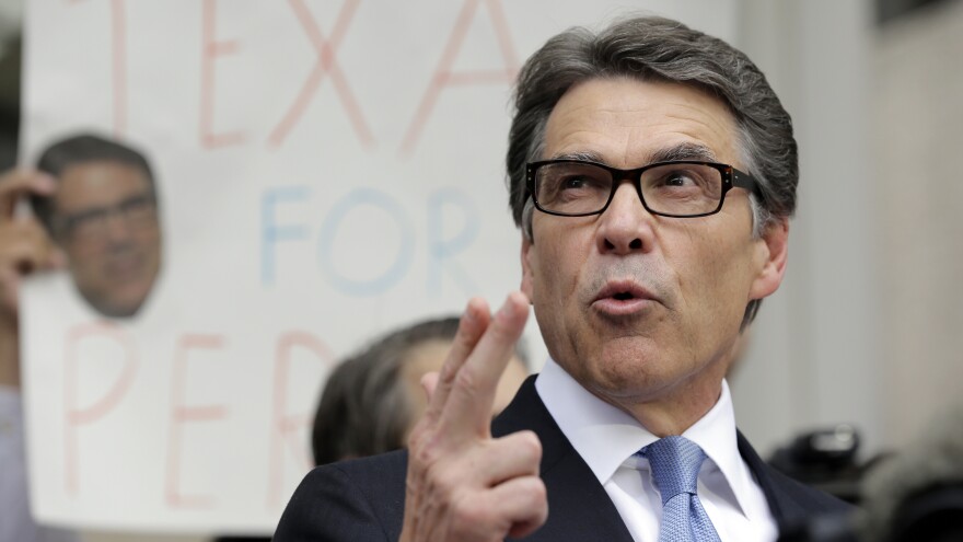 Texas Gov. Rick Perry talks to the media and supporters after he was booked on August 19 in Austin. Perry is charged with abuse of office and coercing a public official.