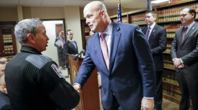 Acting Attorney General Matthew Whitaker shakes hands with Newtown Police Chief Tom Synan during a news conference, Friday, Nov. 30, 2018, in Cincinnati.