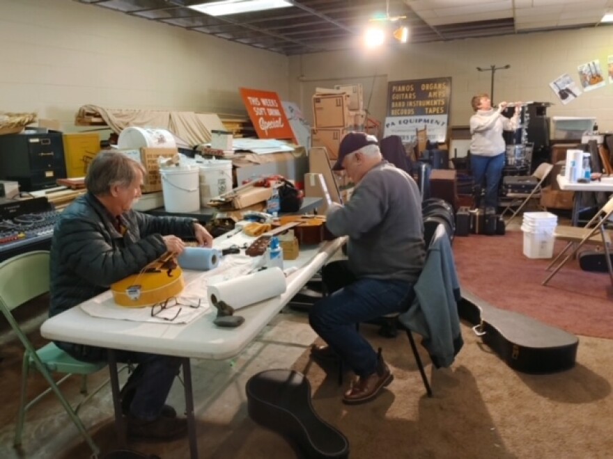 John Hamlett and Doug Naselroad are among a group restoring instruments for the WoodSongs Tornado Relief Effort at Currier's Music World in Richmond, Kentucky.