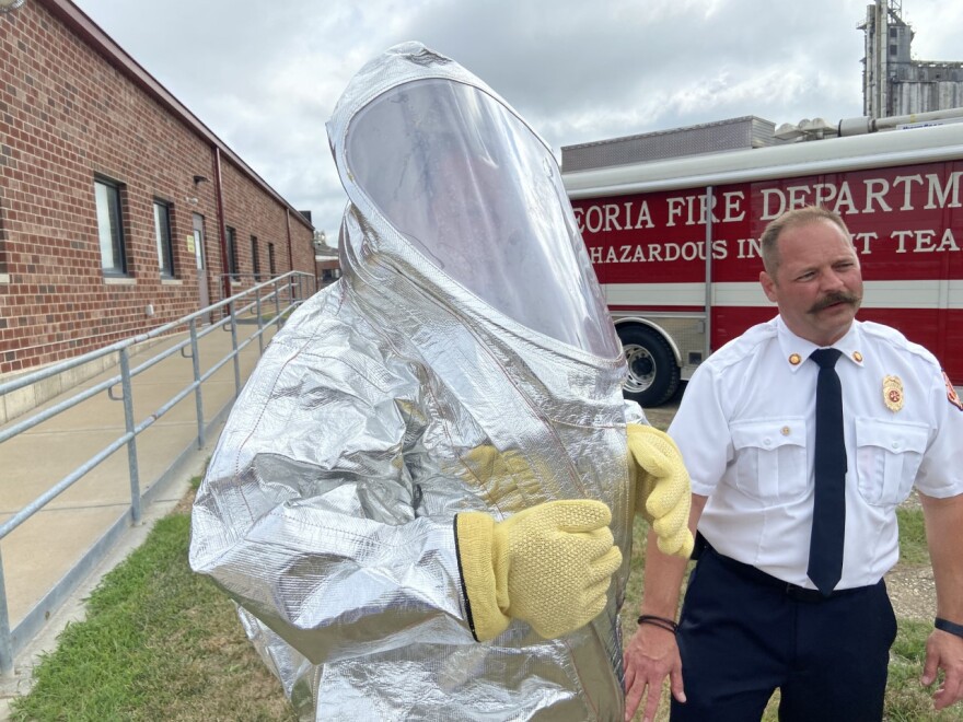 Peoria Fire Department's Scott Venzon and Nate Rice try out a new protective suit donated by BioUrja.