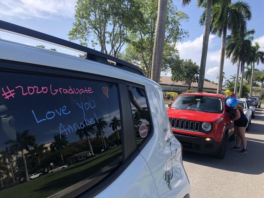 A congratulations message is scrawled on a car window for a surprise graduation parade honoring Annabel Claprood.