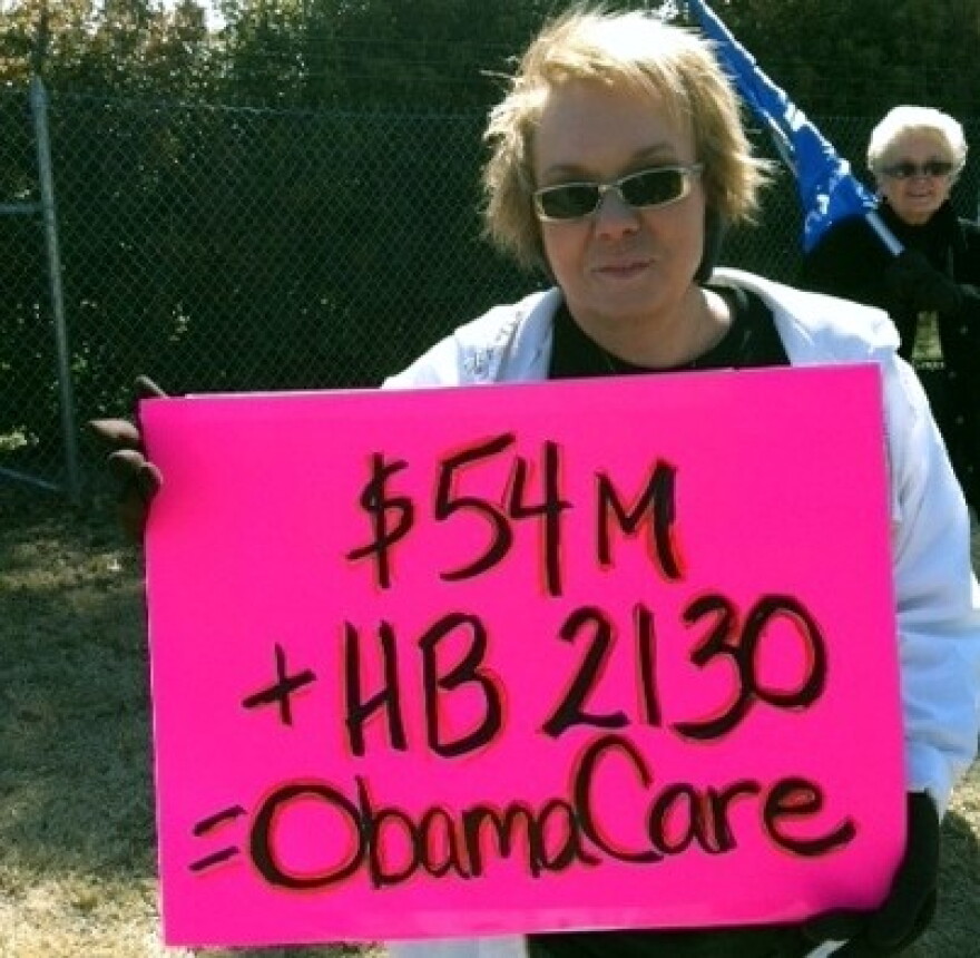 One of the protesters at the Tulsa Country Club.