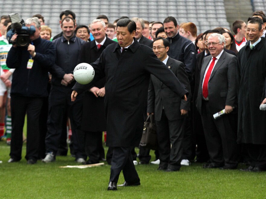 Xi Jinping, an avowed soccer fan, kicks a Gaelic football during a 2012 trip to Dublin when he was China's vice president. Xi became president the following year.