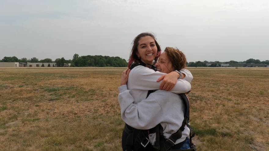 Barbara Allison hugs her daughter, Camille, after completing a dive near Grand Haven, MI, on June 10, 2023