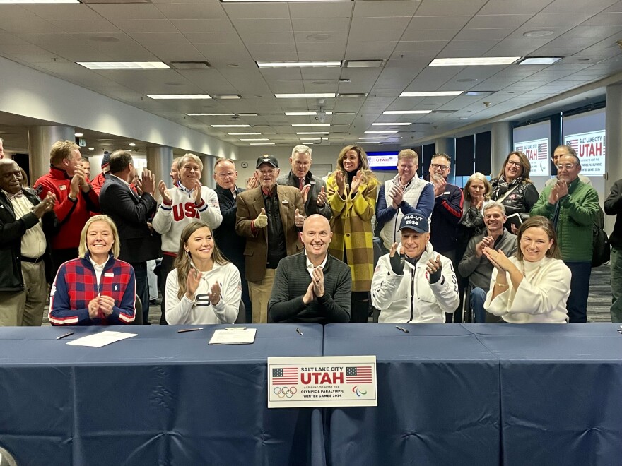 Utah Gov. Spencer Cox and Salt Lake City Erin Mendenhall along with members of the Winter Olympics organizing committee celebrate the progress of the 2034 bid at Rice-Eccles Stadium in Dec. 2023.