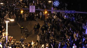 Police (center) had to move in to disperse the crowd in the streets of State College, Pa., Wednesday night after students and others gathered to protest the firing of football coach Joe Paterno.