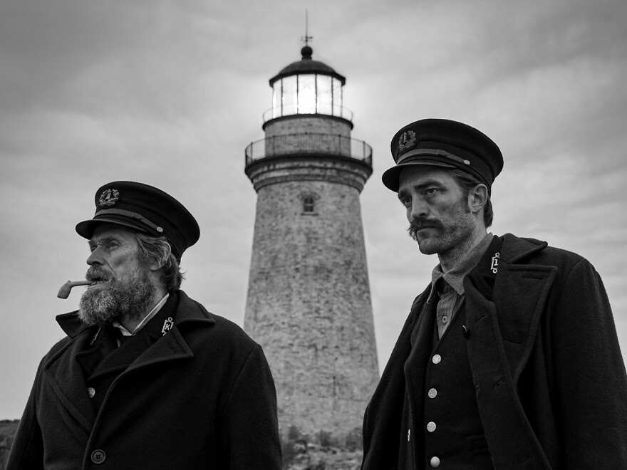 Williem Dafoe, left, and Robert Pattinson are stranded during a bad storm in <em>The Lighthouse.</em>