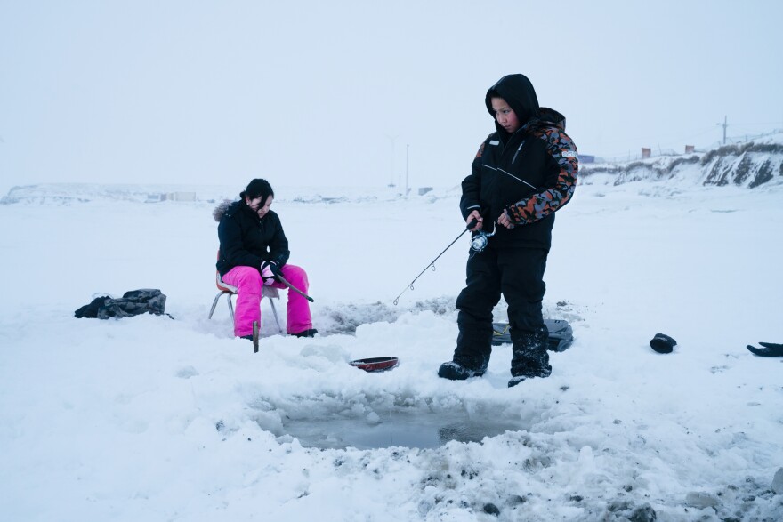 Joanna Woods, 12, (left) and her cousin Mick Chakuchin, 10, go ice fishing in Toksook Bay.