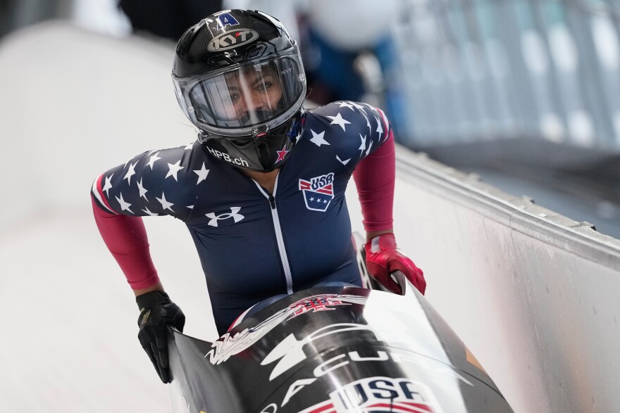 Winner Kaysha Love of the United States celebrates after the women's monobob race at the Bobsleigh World Cup in Innsbruck, Austria, Saturday, Nov. 29, 2025.