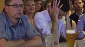 Bar patrons watch the Oct. 3 presidential debate at Bullfeathers, a bar a short distance from the U.S. Capitol. Drinking and debate-watching often go hand in hand — to the point where drinking games have been developed around watching the debates.