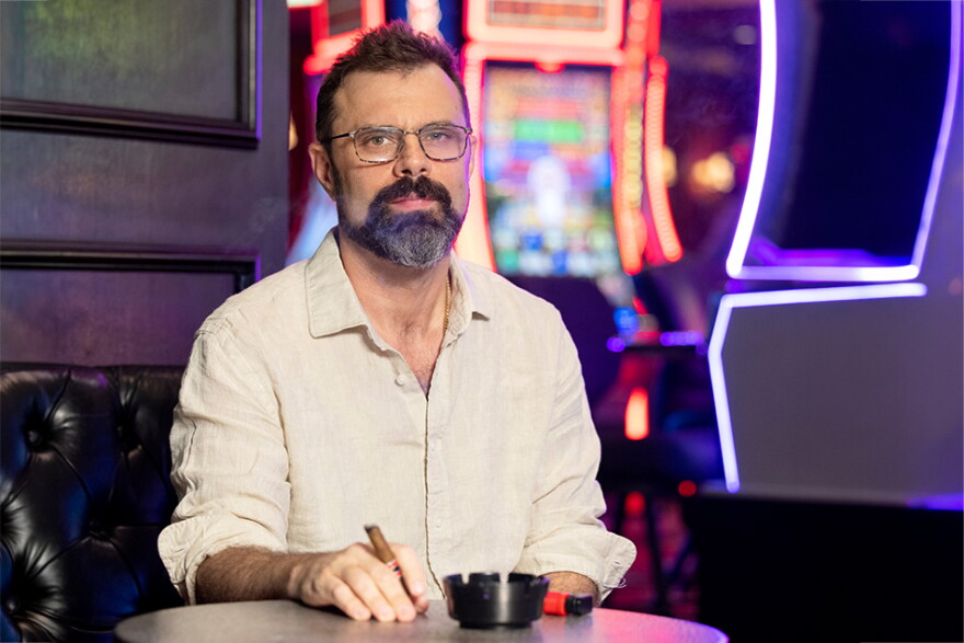 Isaac Reed smokes a cigar in a local Vegas casino.