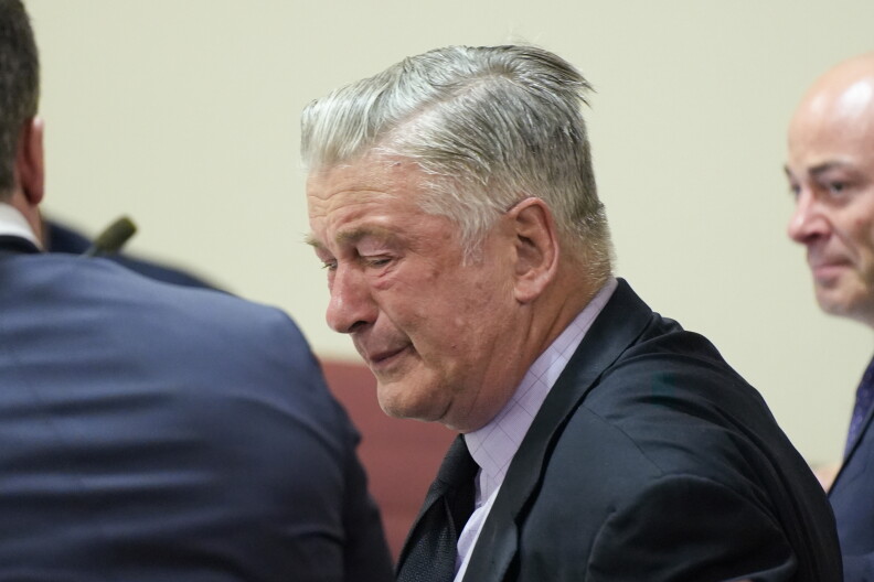 FILE - Actor Alec Baldwin, center, reacts as he sits between his attorneys Alex Spiro, left, and Luke Nikas after the judge threw out the involuntary manslaughter case for the 2021 fatal shooting of cinematographer Halyna Hutchins during filming of the Western movie "Rust," Friday, July 12, 2024, in Santa Fe, N.M. Hannah Gutierrez-Reed, a movie armorer has asked a judge to dismiss her involuntary manslaughter conviction, Tuesday, July 16, 2024 or offer her a new trial in the shooting death of a cinematographer by Alec Baldwin. (Ramsay de Give/Pool Photo via AP, File)