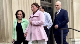 Kim Phuong Taylor (center) leaves the Federal Courthouse in Sioux City after her sentencing for voter fraud on April 1, 2024. She is joined by family, including her mother, son Ishmael, and husband, Jeremy Taylor. (Sheila Brummer, Iowa Public Radio)