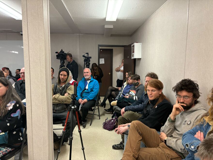 Community members filled available seating, with many more listening to the meeting from a speaker outside.