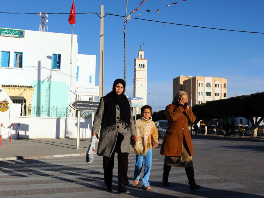 People walk in the street in Sidi Bouzid on Jan. 10.