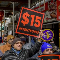 People protest for a $15 minimum wage in New York City in 2017.