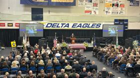 Pastor Brian White of Harvest Church starting the funeral service at Delta High School.