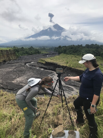 Ashley Bosa and a fellow researcher set up mudflow monitoring equipment in the shadow of Fuego Volcano in Guatemala.